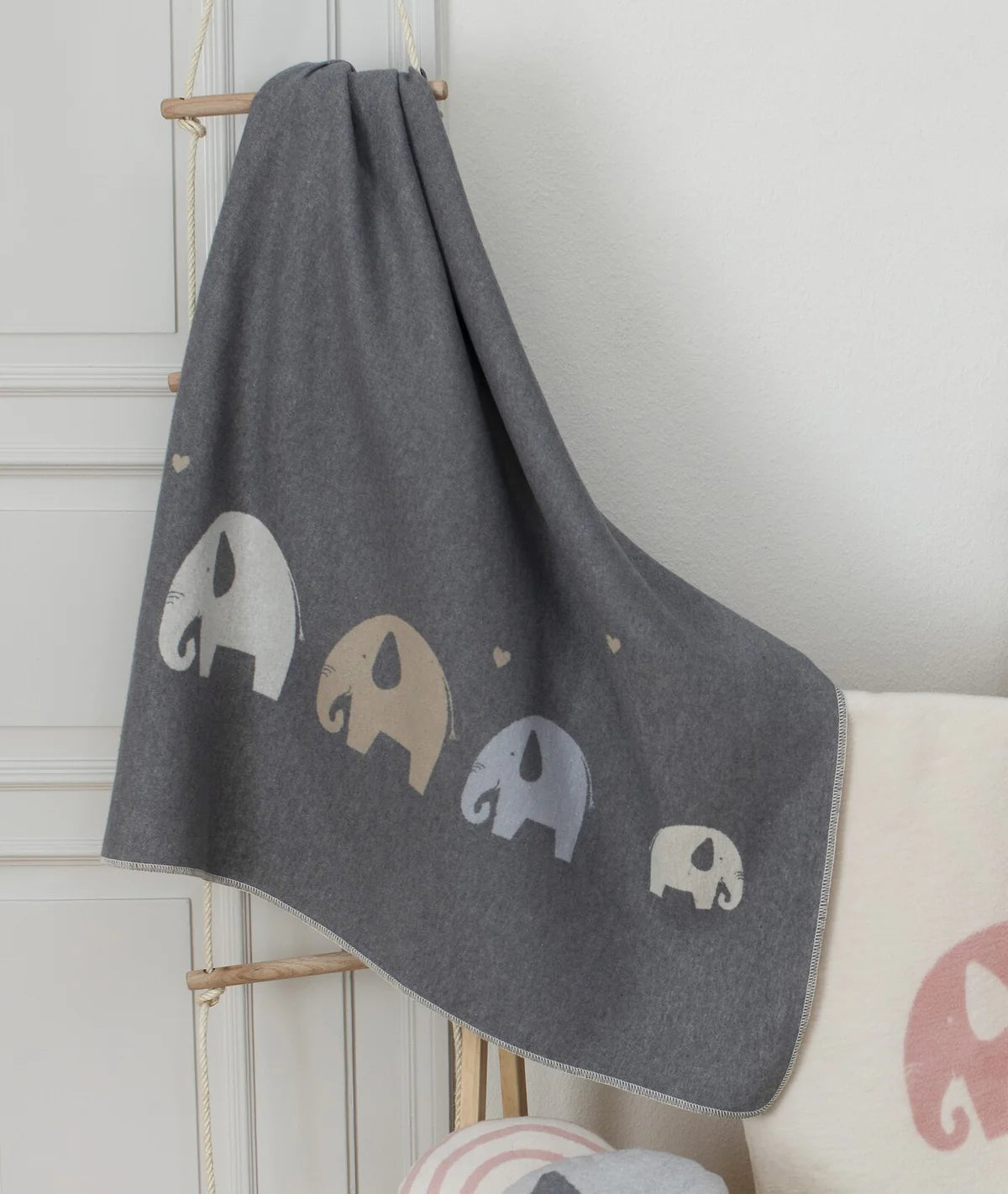 Soft blankets and swaddles neatly folded in a baby nursery