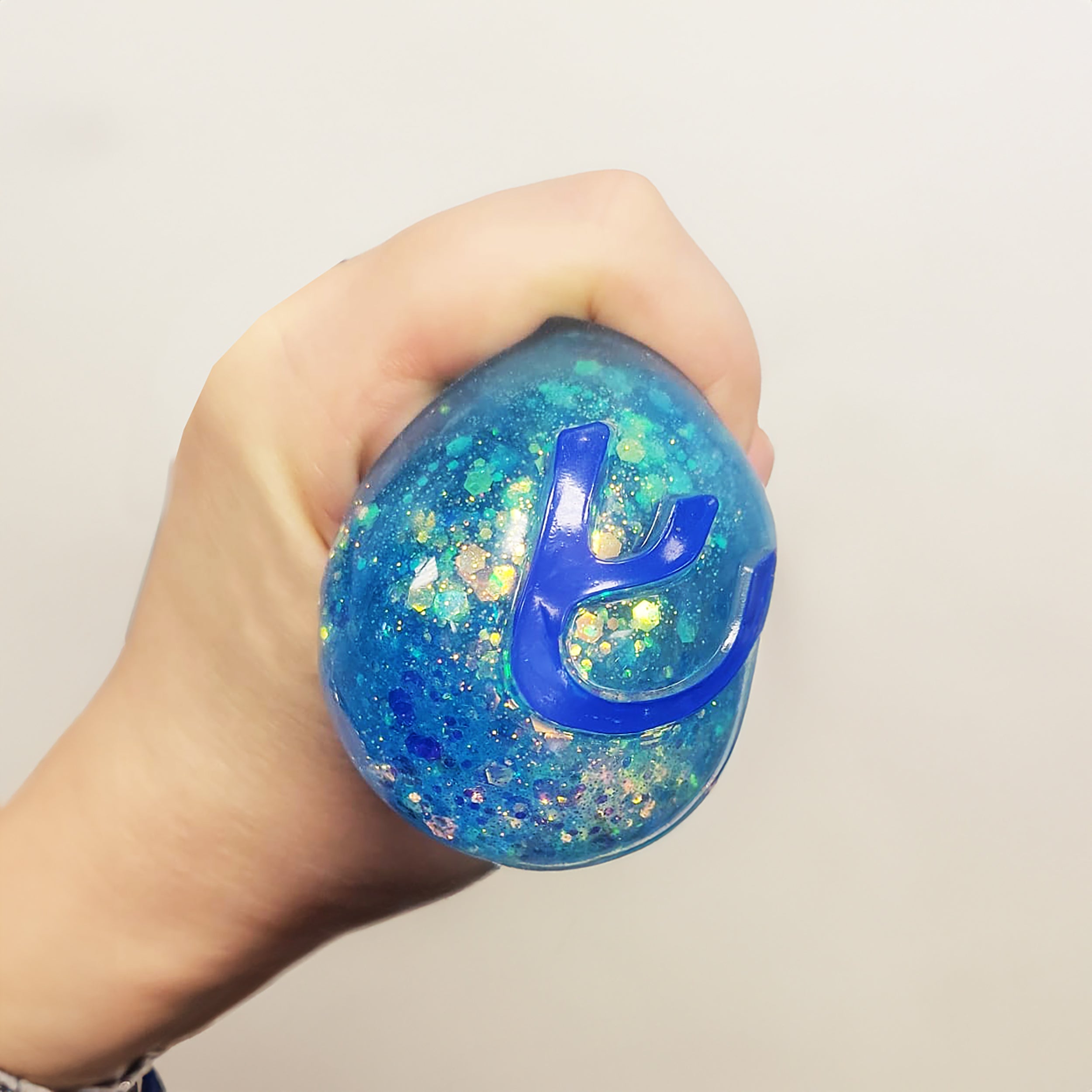 Dreidel Squish rempli de paillettes irisées